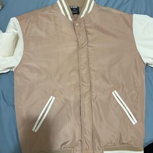 Men’s tan and white varsity jacket
